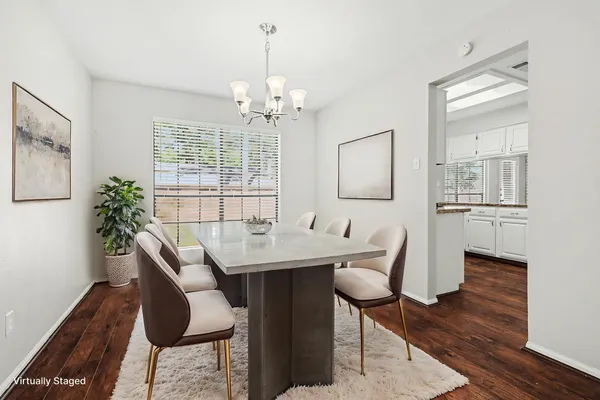 a view of a dining room with furniture wooden floor and chandelier