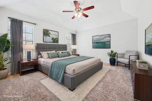 a bedroom with a bed couch and a window