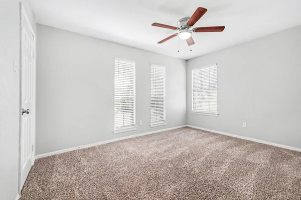 a view of a livingroom with a ceiling fan and window