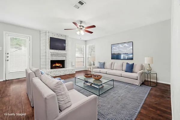 a living room with furniture fireplace and flat screen tv