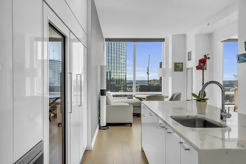 a kitchen with kitchen island a sink table and chairs