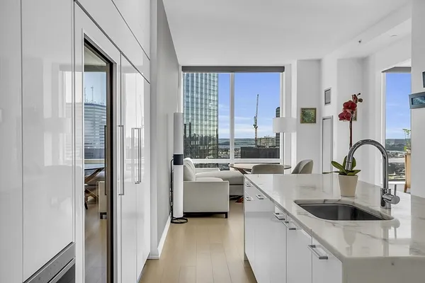 a kitchen with kitchen island a sink table and chairs