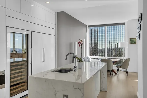 a kitchen with a sink cabinets and stainless steel appliances