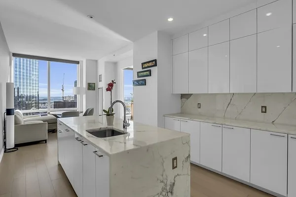 a kitchen with stainless steel appliances granite countertop a sink a stove and a refrigerator
