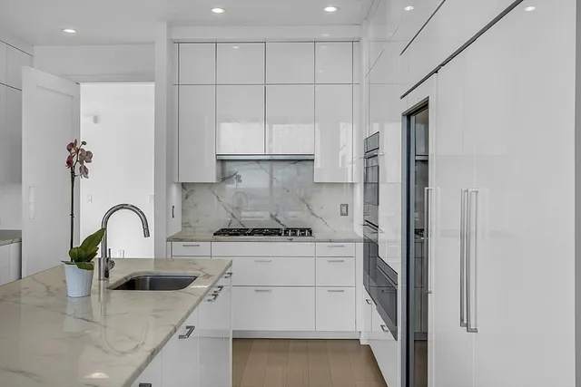 a spacious bedroom with a bed and glass window