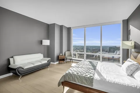 a bathroom with a granite countertop sink and a large mirror
