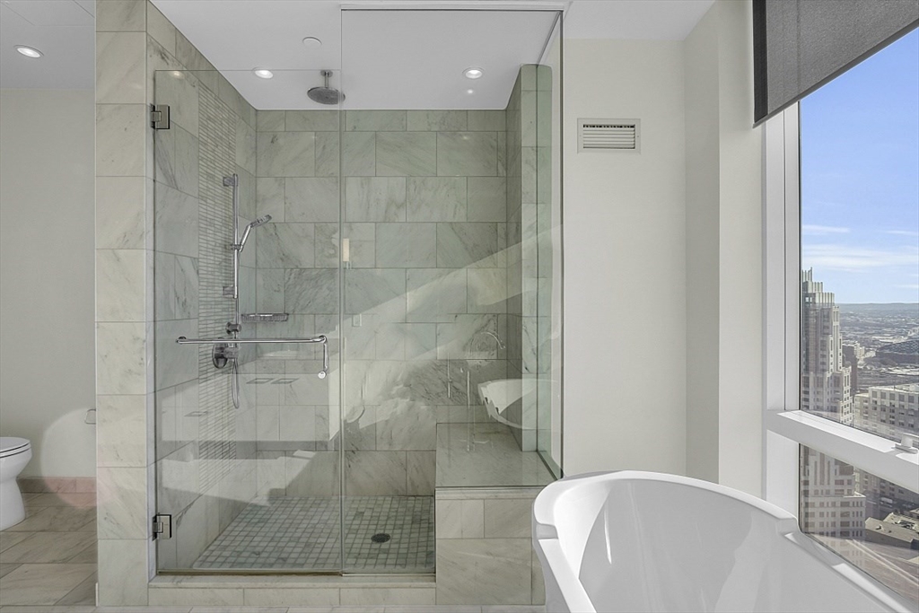 1 Franklin Street, Unit 4606 Boston, MA 02110 - Photo 19 of 38 a bathroom with a bathtub and shower