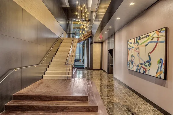 a living room with furniture and a chandelier