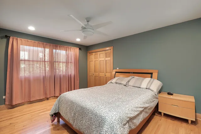 a bedroom with a large bed and a large window