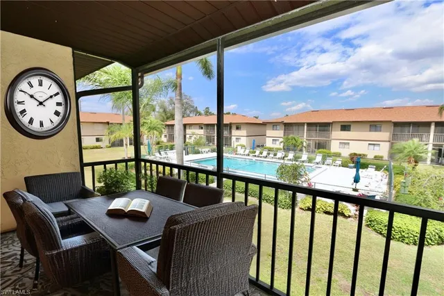 a view of a city from a balcony with furniture