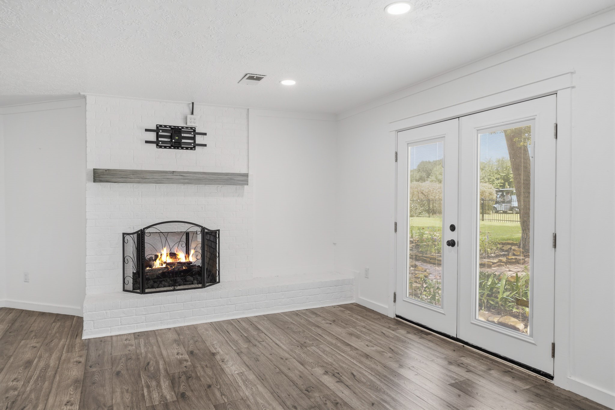 79 Summers Wind Street Conroe, TX 77356 - Photo 20 of 45 an empty room with windows and a fireplace