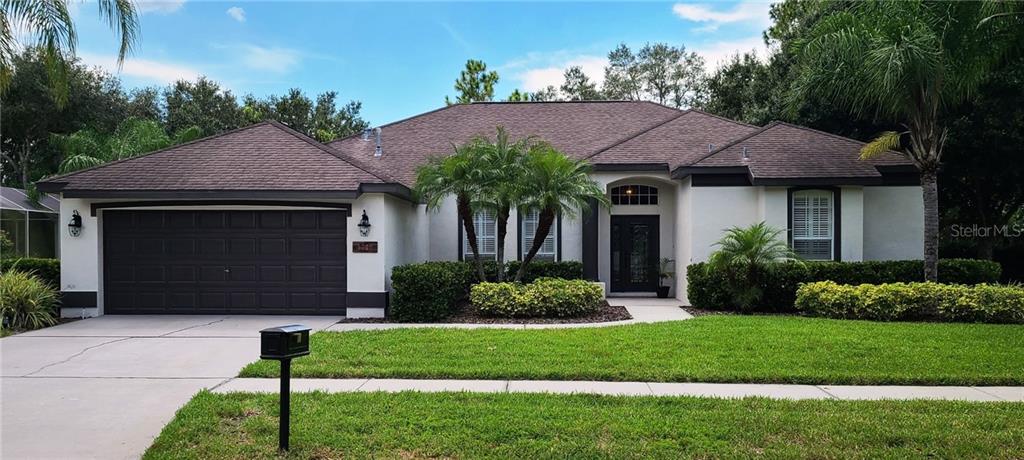 5721 Tanagerside Road Lithia, FL 33547 - Photo 1 of 1 a front view of a house with a garden