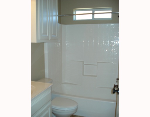 213 Country Club Boulevard Portland, TX 78374 - Photo 8 of 10 a bathroom with a shower and a toilet