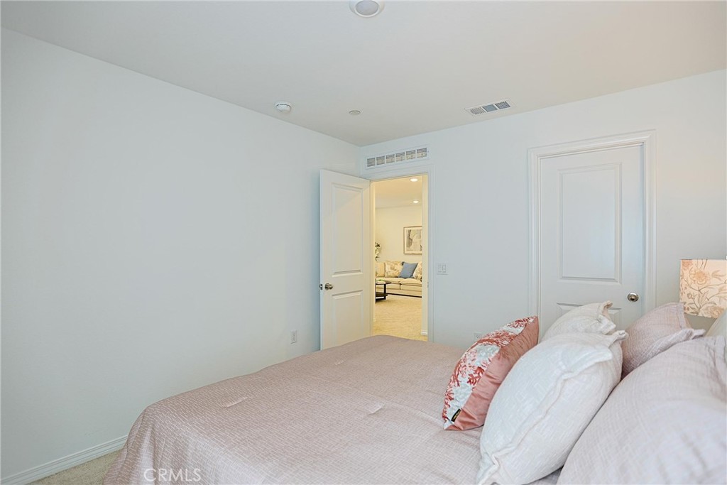 7486 Olive Grv Street Riverside, CA 92507 - Photo 36 of 57 a bedroom with a bed and a window