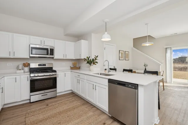 a kitchen with a stove top oven sink and cabinets