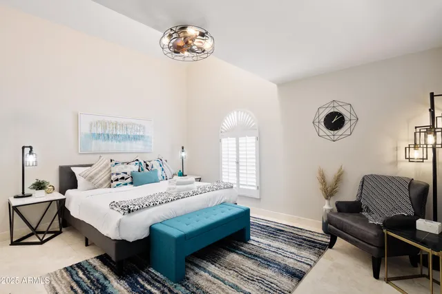 a bedroom with a bed and a table