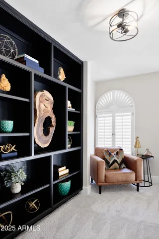 a bedroom with a bed a table and chair