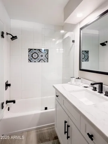 a bedroom with a bed and a ceiling fan