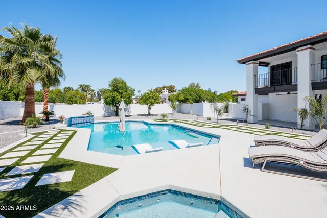 a view of a swimming pool with chairs