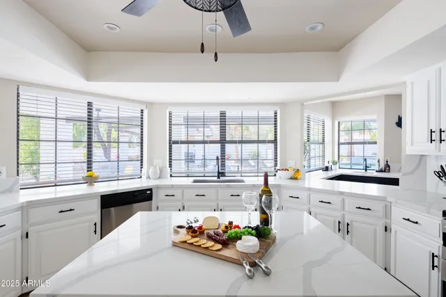 a large white kitchen with a large window