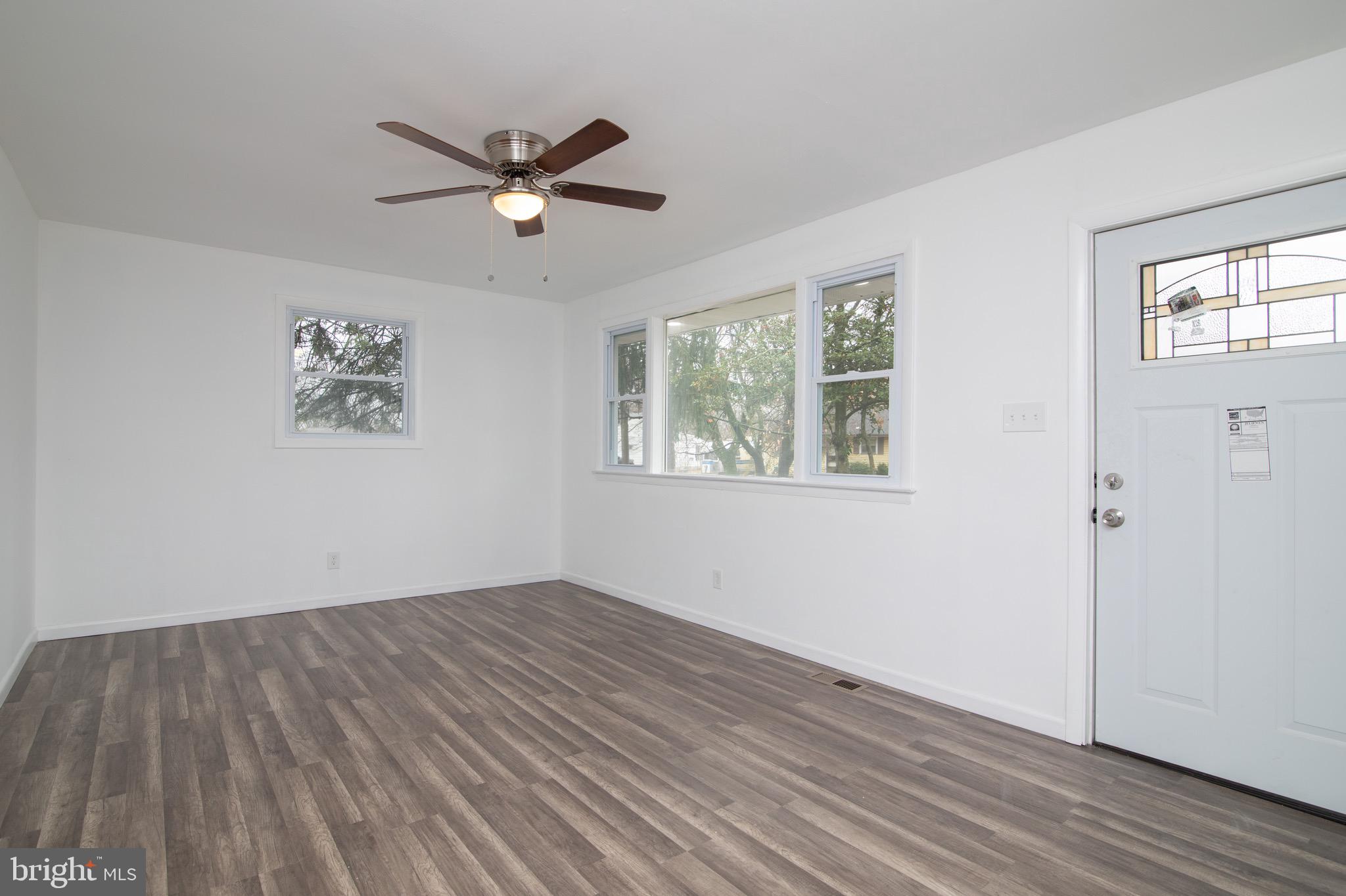 112 Country Club Road Pine Hill, NJ 08021 - Photo 2 of 22 a view of empty room with wooden floor and fan