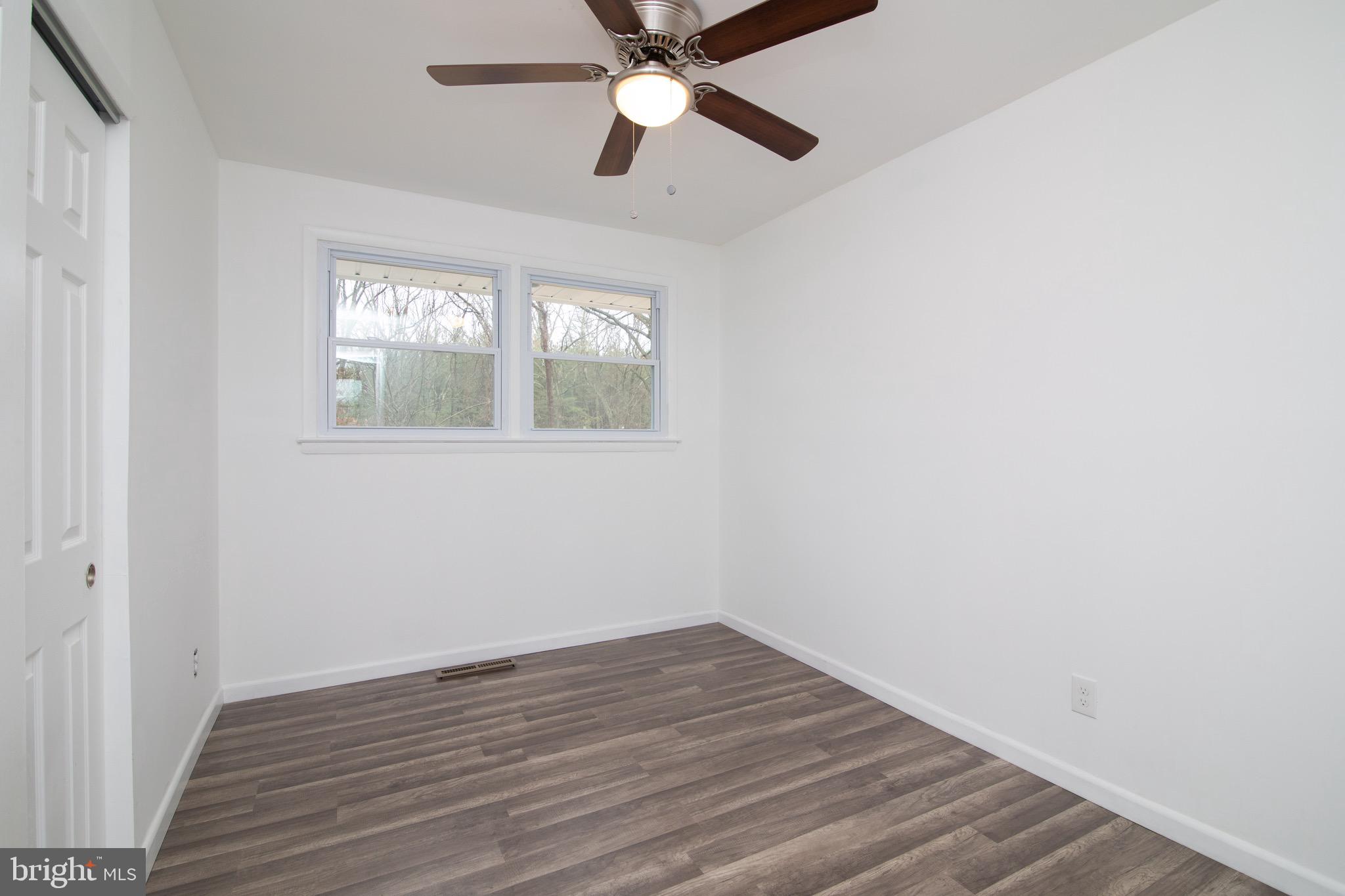 112 Country Club Road Pine Hill, NJ 08021 - Photo 14 of 22 wooden floor in an empty room with a window