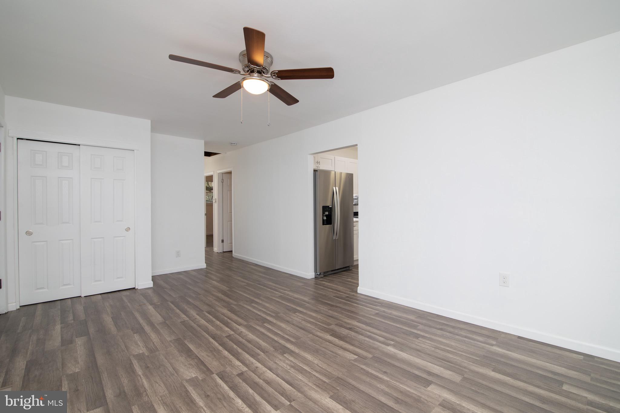 112 Country Club Road Pine Hill, NJ 08021 - Photo 15 of 22 a view of a room with wooden floor and a ceiling fan