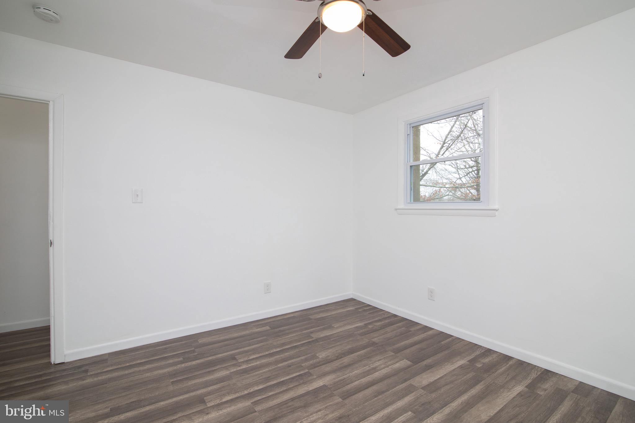 112 Country Club Road Pine Hill, NJ 08021 - Photo 17 of 22 an empty room with wooden floor and windows