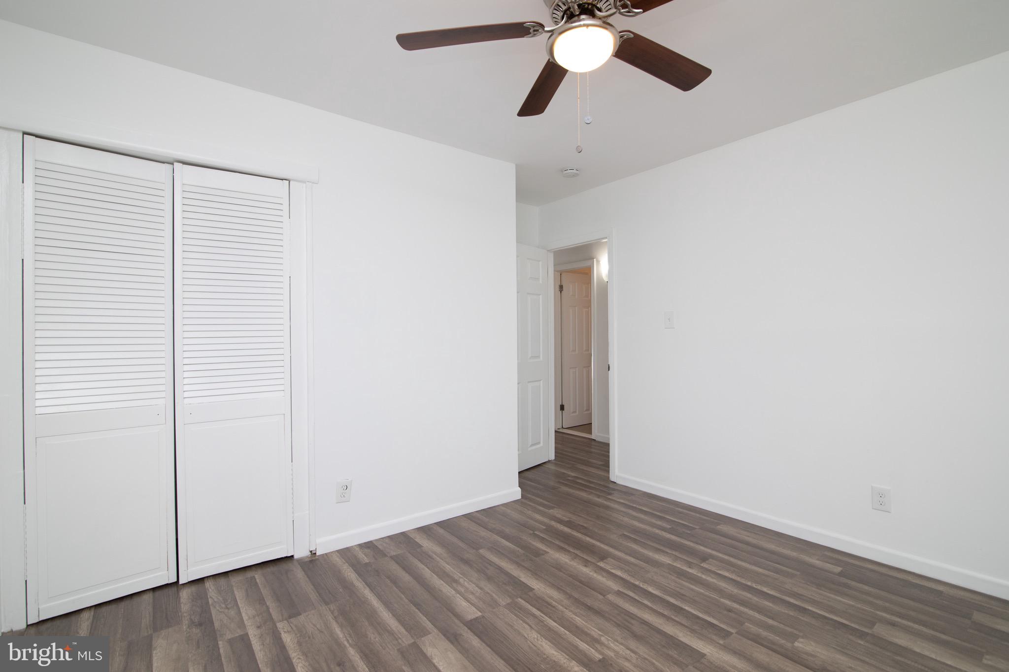 112 Country Club Road Pine Hill, NJ 08021 - Photo 18 of 22 an empty room with wooden floor closet and fan