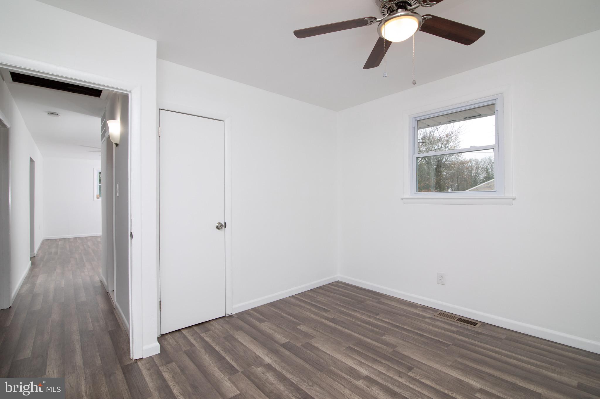 112 Country Club Road Pine Hill, NJ 08021 - Photo 7 of 22 a view of an empty room with wooden floor and a window