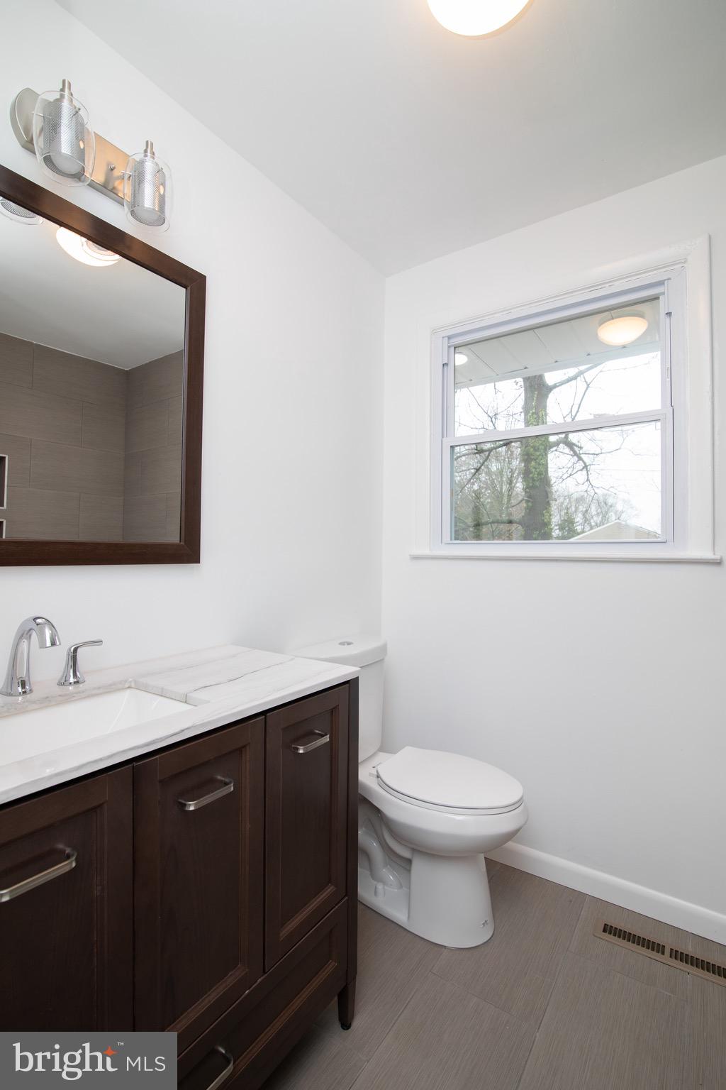 112 Country Club Road Pine Hill, NJ 08021 - Photo 10 of 22 a bathroom with a toilet sink and mirror