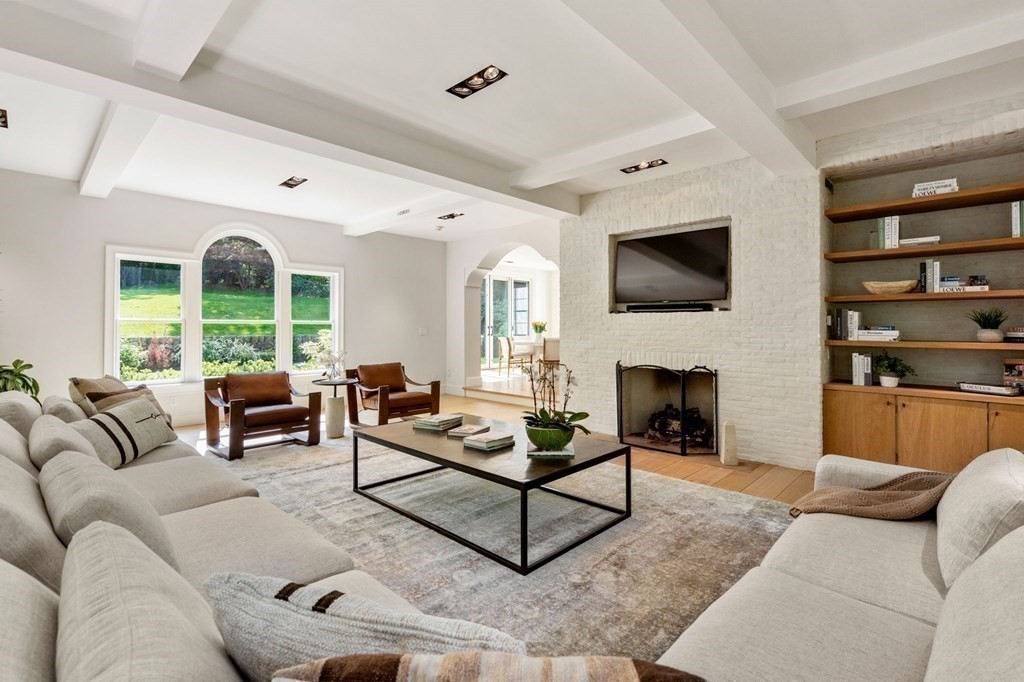 82 Sargent Road Brookline, MA 02445 - Photo 13 of 41 a living room with furniture a fireplace and a flat screen tv