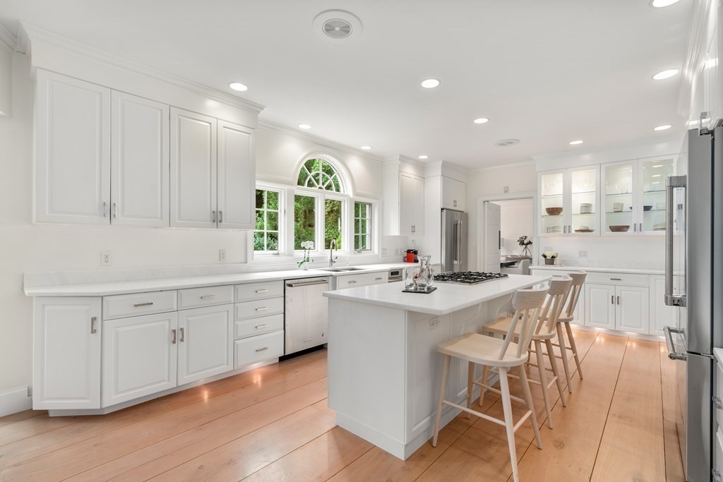 82 Sargent Road Brookline, MA 02445 - Photo 17 of 41 a kitchen with white cabinets and chairs