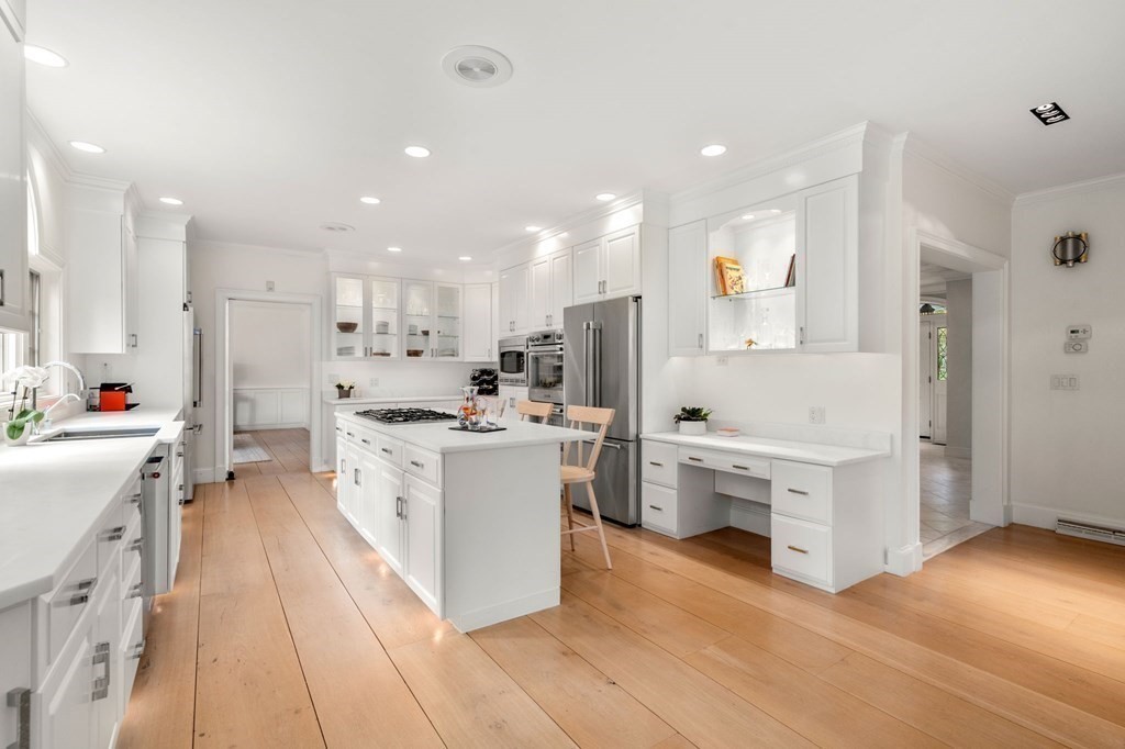 82 Sargent Road Brookline, MA 02445 - Photo 18 of 41 a kitchen with white cabinets and stainless steel appliances