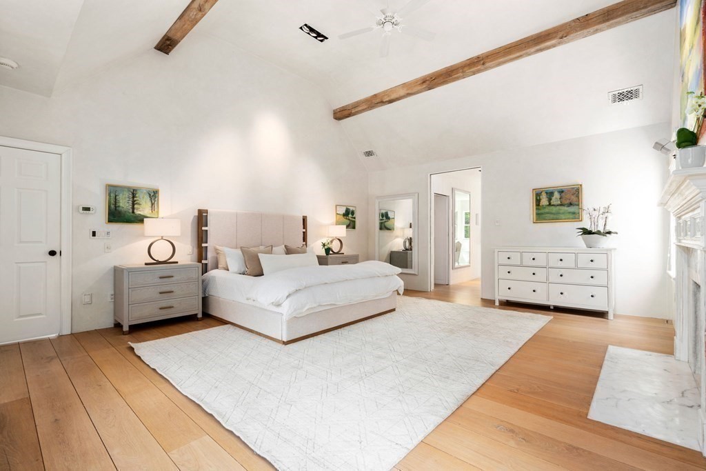 82 Sargent Road Brookline, MA 02445 - Photo 23 of 41 a spacious bedroom with a bed a couch and a window