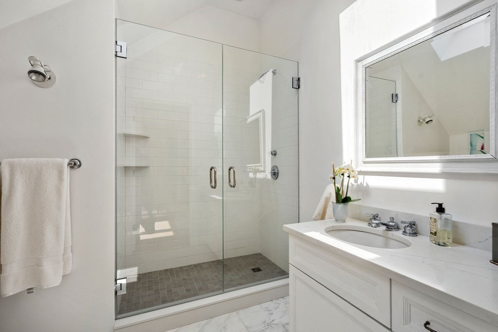 82 Sargent Road Brookline, MA 02445 - Photo 33 of 41 a bathroom with a shower sink and mirror