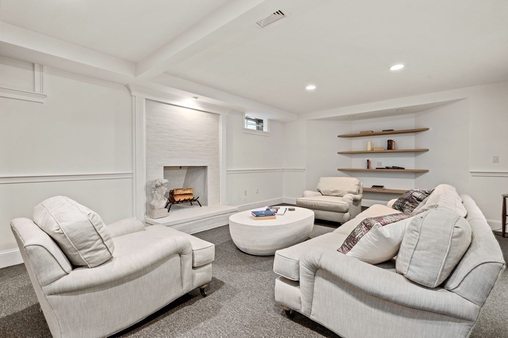 82 Sargent Road Brookline, MA 02445 - Photo 34 of 41 a living room with furniture and a fireplace