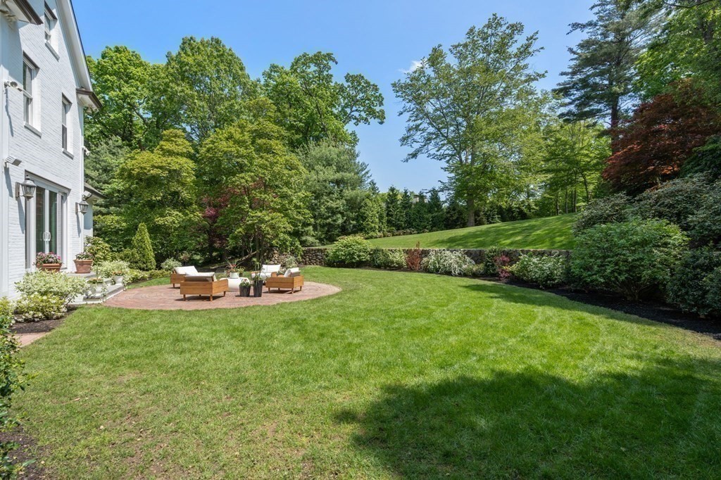 82 Sargent Road Brookline, MA 02445 - Photo 36 of 41 a view of a backyard with a garden and seating area