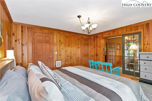 a bedroom with a bed and a chandelier