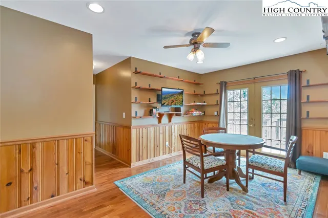 a dining room with furniture a rug and wooden floor