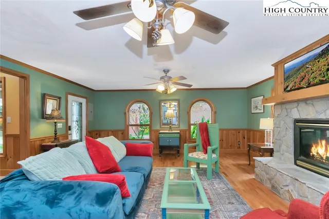 a living room with furniture a flat screen tv and a fireplace