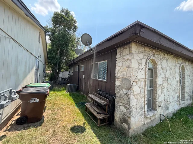 a backyard of a house with table and chairs