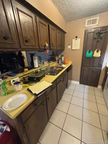 a kitchen with a sink appliances and cabinets