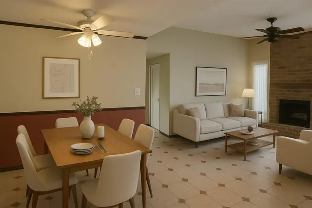 a living room with furniture a fireplace and a ceiling fan