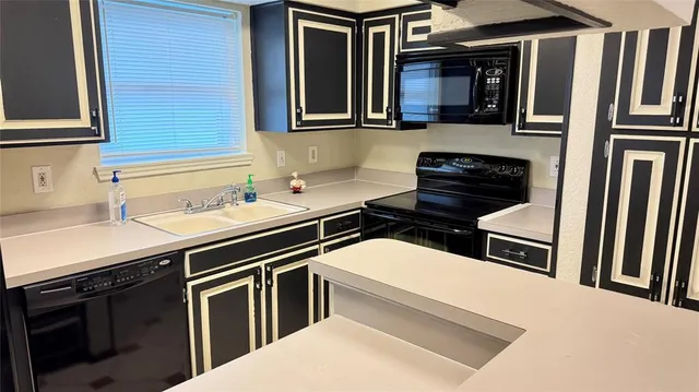a kitchen with stainless steel appliances a stove and a sink