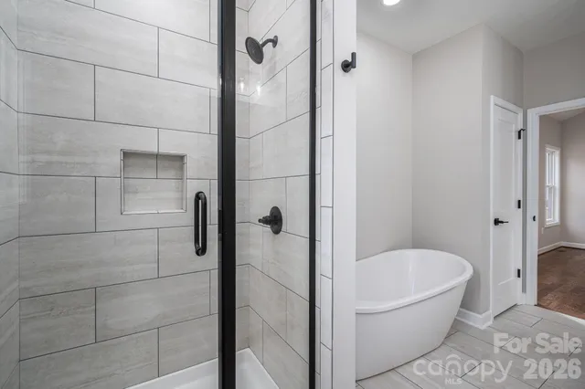 a bathroom with a bathtub and shower