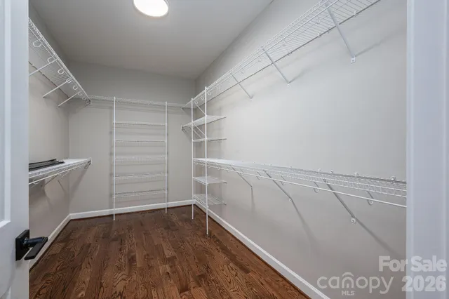 a view of walk in closet with empty racks