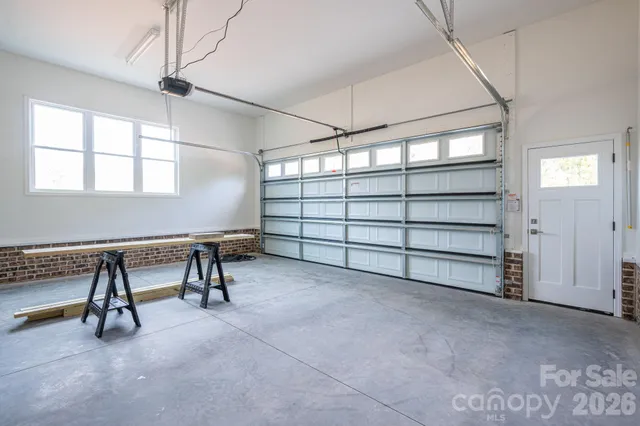 a view of an empty room with furniture and a window