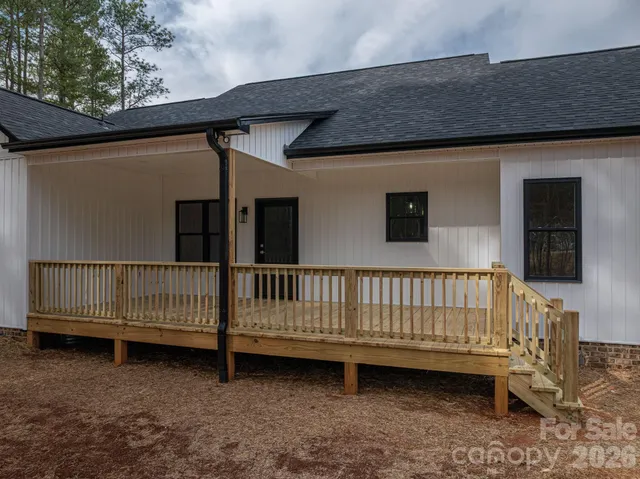 a view of backyard with deck and backyard