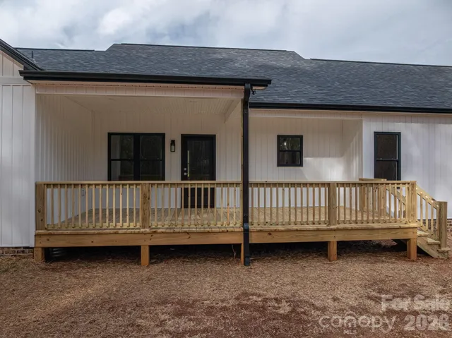 a view of a house with wooden fence
